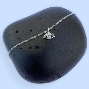 Silver anklet with an evil eye charm with white gemstone in the centre.