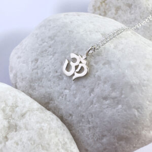 Spiritual anklet with a silver ohm sign charm.