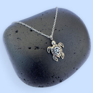 Silver anklet with a sea turtle charm with ionised silver detail.