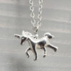 Close up of sterling silver anklet with unicorn charm.