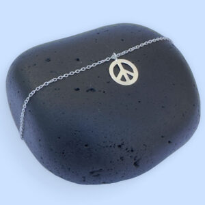 Silver anklet with a peace symbol charm.