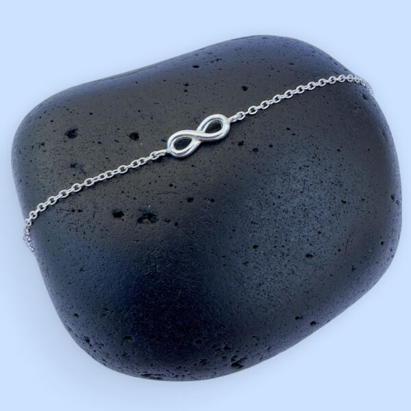 Chunky sterling silver infinity charm on a silver ankle bracelet.