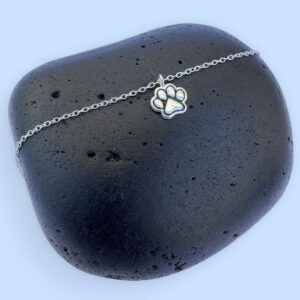 Cute silver anklet with a charm of a pawprint with ionised silver detail.