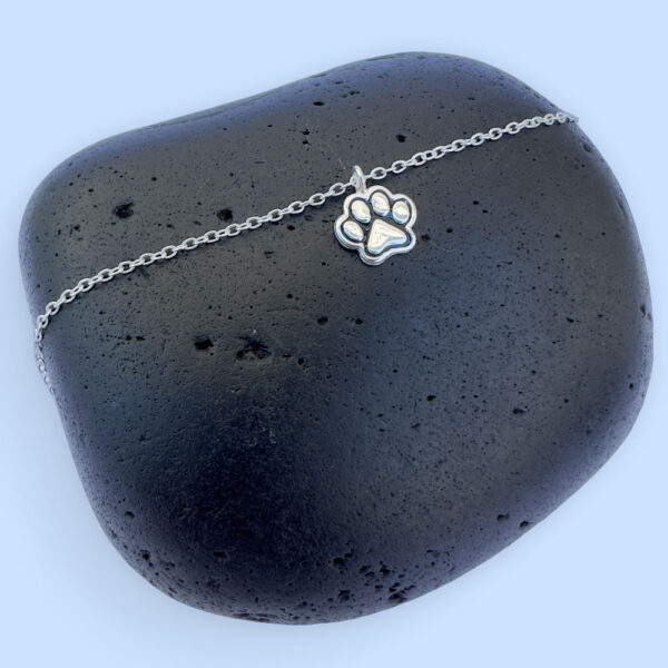 Cute silver anklet with a charm of a pawprint with ionised silver detail.