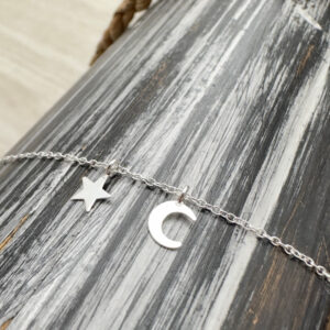 Sterling silver ankle bracelet with a dainty star and crescent moon charm.