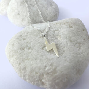 Powerful energy silver anklet with a charm of a lightening bolt.