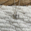 Sterling silver bee charm on a silver ankle bracelet.
