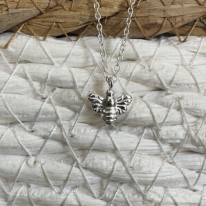 Sterling silver bee charm on a silver ankle bracelet.