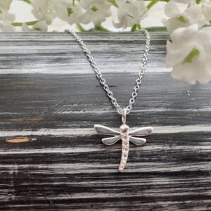 Silver anklet with a silver dragonfly charm with cubic zirconia stones down its middle.