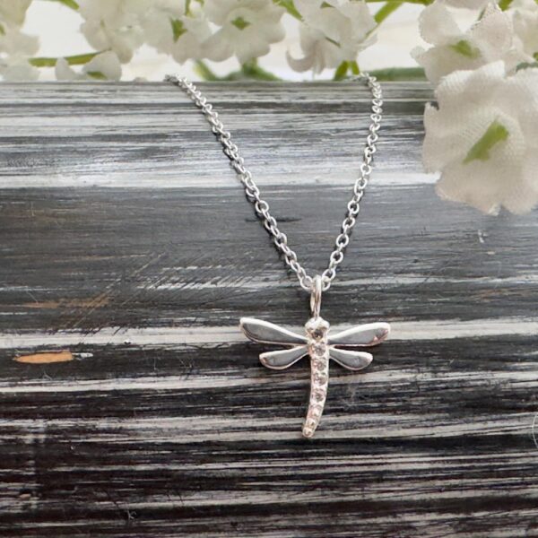 Silver anklet with a silver dragonfly charm with cubic zirconia stones down its middle.