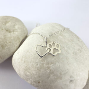 Silver anklet of a linked heart and pawprint.