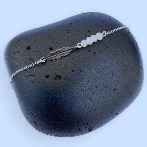 Sterling silver dainty anklet with an iodised silver style feather charm and four white beads.