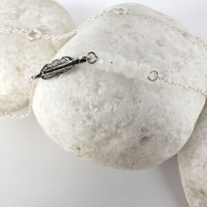 Dainty sterling silver anklet with an iodised silver style feather charm and four white beads.