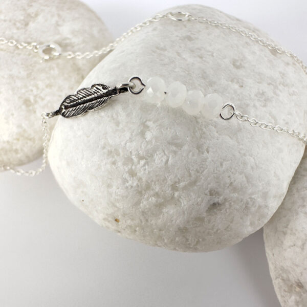 Dainty sterling silver anklet with an iodised silver style feather charm and four white beads.
