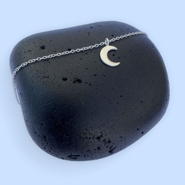 Stunning silver anklet with a crescent moon charm.