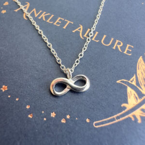 Infinity silver charm on anklet.