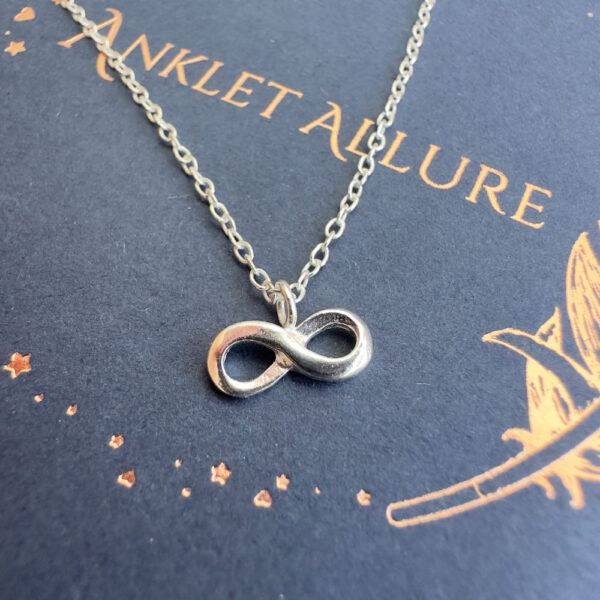 Infinity silver charm on anklet.