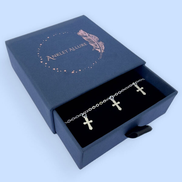 Silver anklet with three silver crosses equally spaced around the chain presented in a blue Anklet Allure jewellery box.