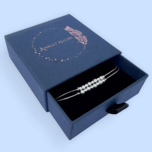 Silver anklet with a double chain with eight balls presented in a dark blue Anklet Allure gift box.