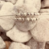 Double chain silver ankle bracelet with eight balls on each of the chains, alternating shiny silver then rough frosted silver.