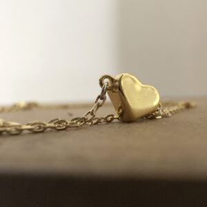 Meaningful solid gold love heart on a simple gold ankle bracelet.