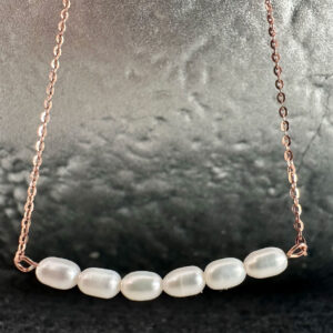 Six oval shaped beautiful freshwater pearls sitting close together on a stunning rose gold ankle chain.