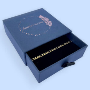 Elegant gold Figaro style ankle bracelet presented in a dark blue Anklet Allure gift box.