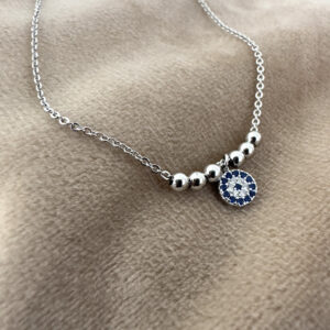 Eye catching 925 sterling silver anklet featuring five silver balls and in the middle a stunning round charm patterned with dark blue gems and cubic zirconia in a circular pattern around the pendant.