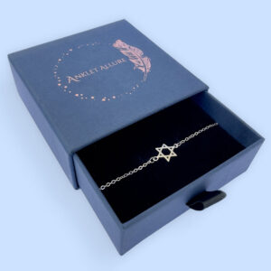 Silver anklet with a star of David charm in a blue jewellery box.
