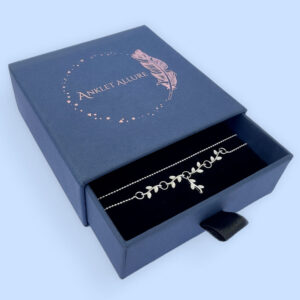 Double chain silver anklet with a beautiful branch and leaf section to the chain in a blue jewellery Anklet Allure box.