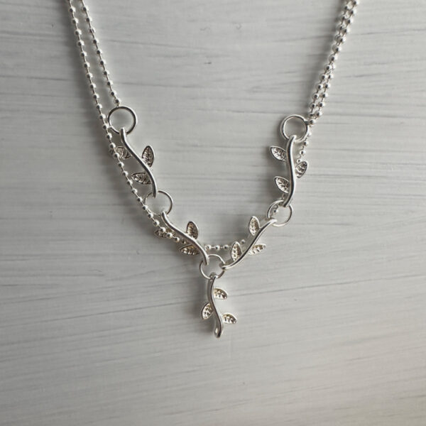 Sterling silver double chain anklet with a solid silver interlinked plant roots feature.