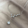 Seven smaller cubic zirconia gems linked together in a pattern similar to the big dipper star formation, with a larger gemstone as the main feature hanging lower from the silver ankle bracelet.
