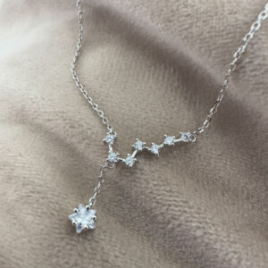 Seven smaller cubic zirconia gems linked together in a pattern similar to the big dipper star formation, with a larger gemstone as the main feature hanging lower from the silver ankle bracelet.