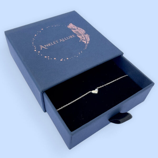 Stunning silver anklet with a cute solid silver heart charm in a blue Anklet Allure jewellery box.