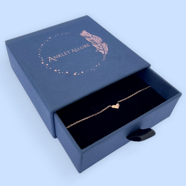 Stunning rose gold anklet with a cute solid rose gold heart charm in a blue Anklet Allure jewellery box.