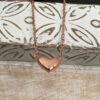 Stunning rose gold anklet with a simple heart charm attached to the ankle chain.