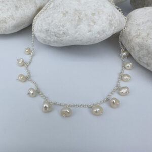 Cute anklet with freshwater pearls hanging all the way around.