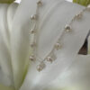 Elegant freshwater pearls at equal distance apart, around a shiny sterling silver ankle chain.
