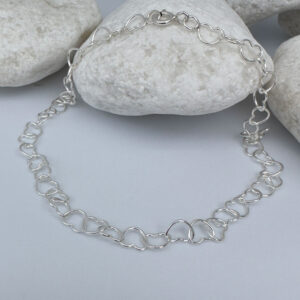 Beautiful silver anklet made of identical linked delicate silver hearts.