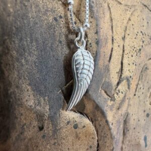 A meaningful silver single angel wing charm on a 925 sterling silver anklet.